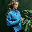 Woman in blue Wilde Funnell Neck Sweater by Ireland's Eye Knitwear